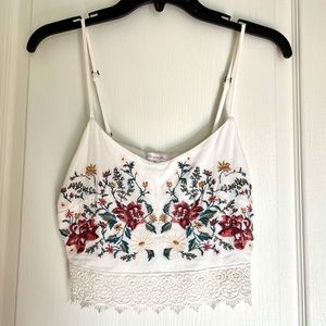 Crop top with sewn floral details.